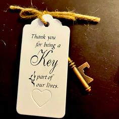 a key is hanging from a string with a thank you for being a key to our lives tag