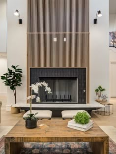 a living room with a large fireplace and two couches in front of the fire place