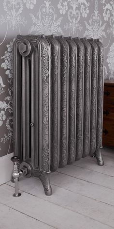 an old fashioned radiator in the corner of a room