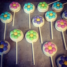 there are many colorful candy lollipops on the stick in the baking pan