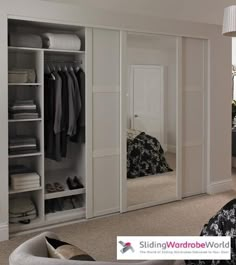 a bedroom with white closets and black bedding