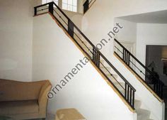 an empty living room with stairs leading up to the second floor