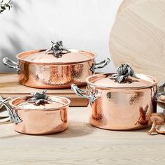 copper pots and pans on a wooden table