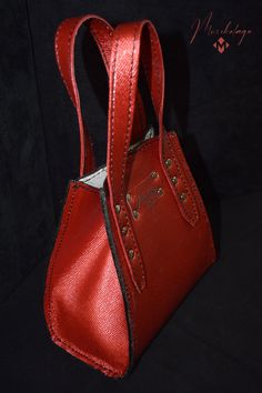 Bogo Leather Handbag, a mini classic purse made of American chrome tanned Cowhide leather and polished with top coat to make it resistance to water. The interior part of the bag is logo printed on lining. Inside the purse there is one small flat pocket. Bottom of the bag is supported by 4 supportive and protective metal feet. The bag opens and closes easily with magnetic snap on top.  Length x Height x Width  7 X 7 X 3.5 Handle (s) drop size: 4 inches Color: Starry ruby red Material: American ch Luxury Small Bags For Everyday Use, Luxury Small Bag For Everyday Use, Small Luxury Evening Bags, Small Luxury Evening Bag, Small Elegant Bag With Detachable Strap, Luxury Small Bag With Removable Pouch, Elegant Small Evening Shoulder Bag, Elegant Small Bag For Everyday Use, Small Elegant Bag For Everyday Use