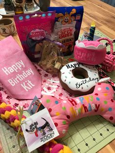 a birthday gift hamper with donuts, doughnut wrappers and other items