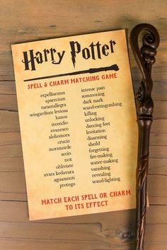 the harry potter spell and charm matching game is displayed on a wooden table with a wand