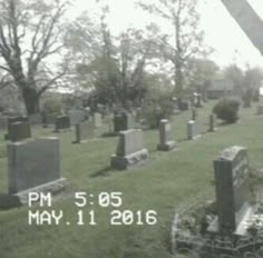 an old cemetery with many headstones and trees in the background