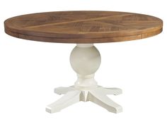 a round wooden table with two white pedestals