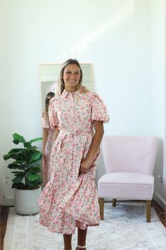 - Collared button-down - Short puff sleeve - Working buttons full length of dress | Nursing friendly - Waist tie | Back elastic at waistline - Pockets - Wide tier at hemline with tiny ruffle detail - Lined - Midi length - Material: 100% Cotton Our Iva Floral Dress displays a beautiful floral print with shades of pink, green, and yellow on a light pink background. This collared button-down dress has working buttons the full length of the dress and is nursing friendly. A waist tie adds the perfect detail. A wide tier with a tiny ruffle detail makes up the hemline and completes the dainty style of the dress. This is such an adorable dress for all occasions! Color Disclaimer: Actual colors may vary due to computer monitors. *Measurements are taken flat, and then doubled.* Size Bust Waist Hips Mission Outfits, Pastel Pink Dress, Light Pink Background, Dress Display, Dainty Style, Short Puff Sleeve, Skirts For Kids, Boys Denim, Nursing Friendly