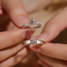 two women's hands holding wedding and engagement rings