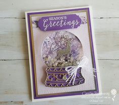 a card with a snow globe on top of it and the words season's greetings