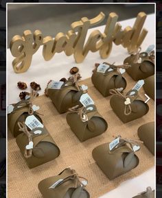 some brown boxes are sitting on a table with tags attached to them that say happy new year