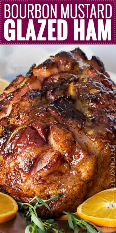 bourbon mustard glazed ham on a platter with oranges