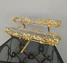 a glass table with gold decorations on it