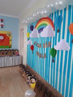 a room filled with balloons and stuffed animals on the wall next to a wooden floor