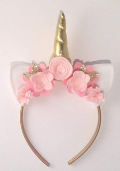 a white and pink cat ears headband with flowers on the top, gold metal hair band