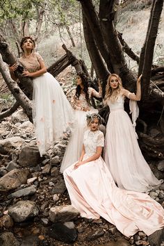 the brides are posing for their wedding pictures in the woods with trees and rocks