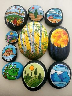 a collection of painted rocks sitting on top of a table