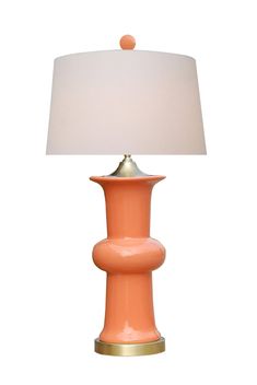 a pink lamp with a white shade on it