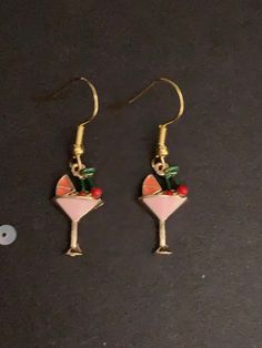 Pair of handmade gold cocktail earrings.  These earrings are made from gold colour cocktail glass charms and gold colour hook fastenings. The are painted with pink, orange, red and green details. The drop measures 3.5cm and they are 1cm wide. They are hand made by me. These earrings are a great gift. All purchases of jewellery or hair accessories come with a free lilac organza gift bag! I currently only post within the UK, Canada, USA and the European Union. Postage for additional items purchase Roses Orange, Cocktail Earrings, Green Details, Glass Charms, Gold Cocktail, Party Earrings, Cocktail Glass, Gold Colour, European Union