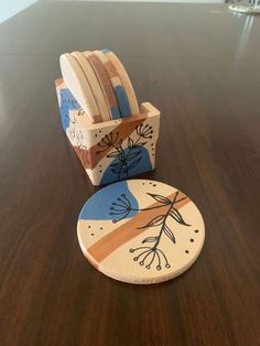 a wooden chair and plate sitting on top of a brown table next to each other