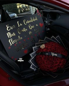 a bouquet of roses and a sign in the back seat of a car