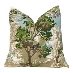 a green and brown pillow with trees on it