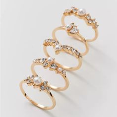 Urban Outfitters Gold Delicate Pearl Ring Set New With Tags Size 7 Delicate Pearl Ring Set. Set Of Five Standout Rings With Pearl And Gem Detailing. Wear Them All Together In A Stack Or Wear On Their Own. Features - Delicate Pearl Ring Set - Set Of Five Rings Content + Care - Set Of Five - Mixed Metal, Glass, Acrylic - Avoid Contact With Water - Imported No Returns Fine Jewelry Stackable Pearl Ring, Stackable 14k Gold Pearl Ring Fine Jewelry, Stackable 14k Gold Pearl Ring, Dainty Gold Stackable Pearl Rings, Yellow Gold Pearl Ring With Pearl Charm, Urban Outfitters Jewelry, Mixed Metals, Pearl Ring, Womens Jewelry Rings