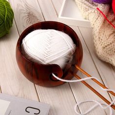 a ball of yarn and knitting needles on a table