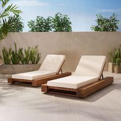 two lounge chairs sitting on top of a white tiled floor next to a planter