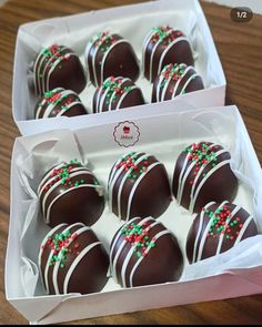 chocolate covered candies are in a box on the wooden table, ready to be eaten