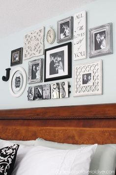 a bed with pictures on the wall above it