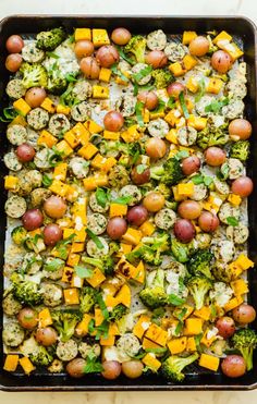 a casserole dish with broccoli, cauliflower and other vegetables