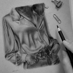 a pencil drawing of a woman's shirt on paper with scissors next to it