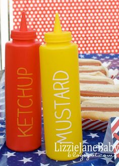 two ketchup bottles sitting next to each other on a table with american flags