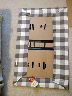 a cardboard house made to look like it is in the middle of some construction paper