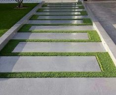 a walkway made out of concrete and artificial grass