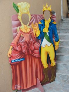 a cardboard cutout of two people dressed as princesses