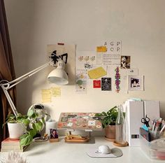 a white desk topped with lots of office supplies