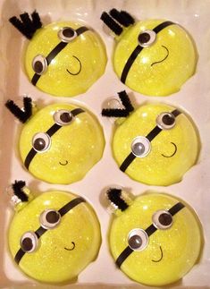 some yellow and black minion faces are in a white box with googly eyes