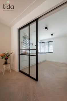 an empty room with wooden floors and sliding glass doors