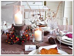 the table is set for thanksgiving dinner with candles