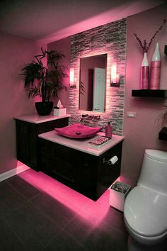 a bathroom with pink lighting in it