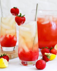 two glasses filled with lemonade and strawberries