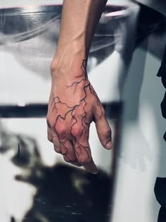 a person's hand with a tattoo on it