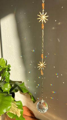 the sun is shining through the window and hanging from a long chain with stars on it