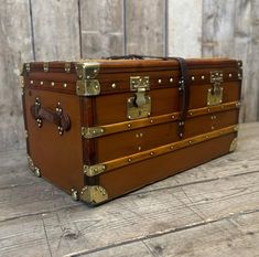 an old trunk sitting on top of a wooden floor