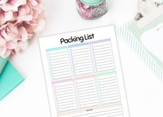 a printable packing list on top of a desk next to flowers and other items