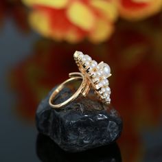 This stunning Gold Polish Pearl ring is ideal for special occasions. Crafted with CZ American Diamonds, Ruby, Emerald, and a large Floral design, it is an eye-catching yet timeless accessory for weddings or other formal events. The beautiful design adds style, personality, wealth, and status. Perfect for traditional Indian outfits like sarees, these rings are perfect for Indian, Pakistani, or Bollywood themed events. Pearl Open Ring For Wedding, Open Pearl Ring For Wedding, Wedding Pearl Open Ring, Pearl Ring For Wedding, Wedding Crystal Open Ring, White Cubic Zirconia Emerald Ring For Wedding, Pearl White Diamond Rings For Wedding, Pearl White Diamond Wedding Ring, Pearl Ring For Party