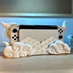 a nintendo wii game console sitting on top of a wooden table